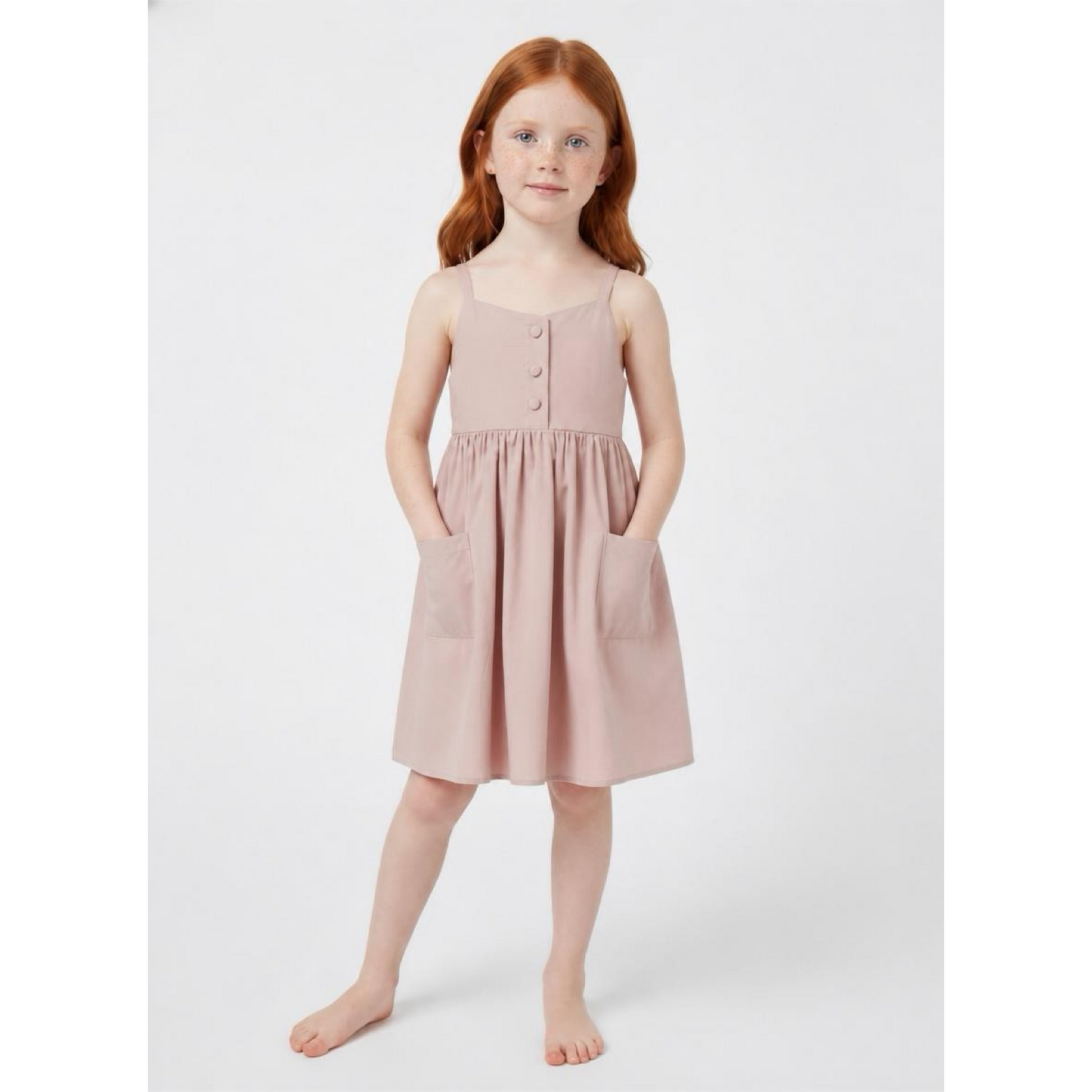 Young girl wearing a pink dress on a white background