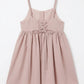 Pink dress with lace-up front on a white background