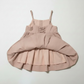Pink dress with ruffled layers on a white background
