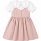 A toddler girl's dress featuring a dusty pink pinafore-style skirt with front pockets and a white short-sleeve top layered underneath, decorated with a large white Peter Pan collar trimmed in pink ruffle.