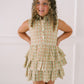 Young girl wearing a floral dress with a white background