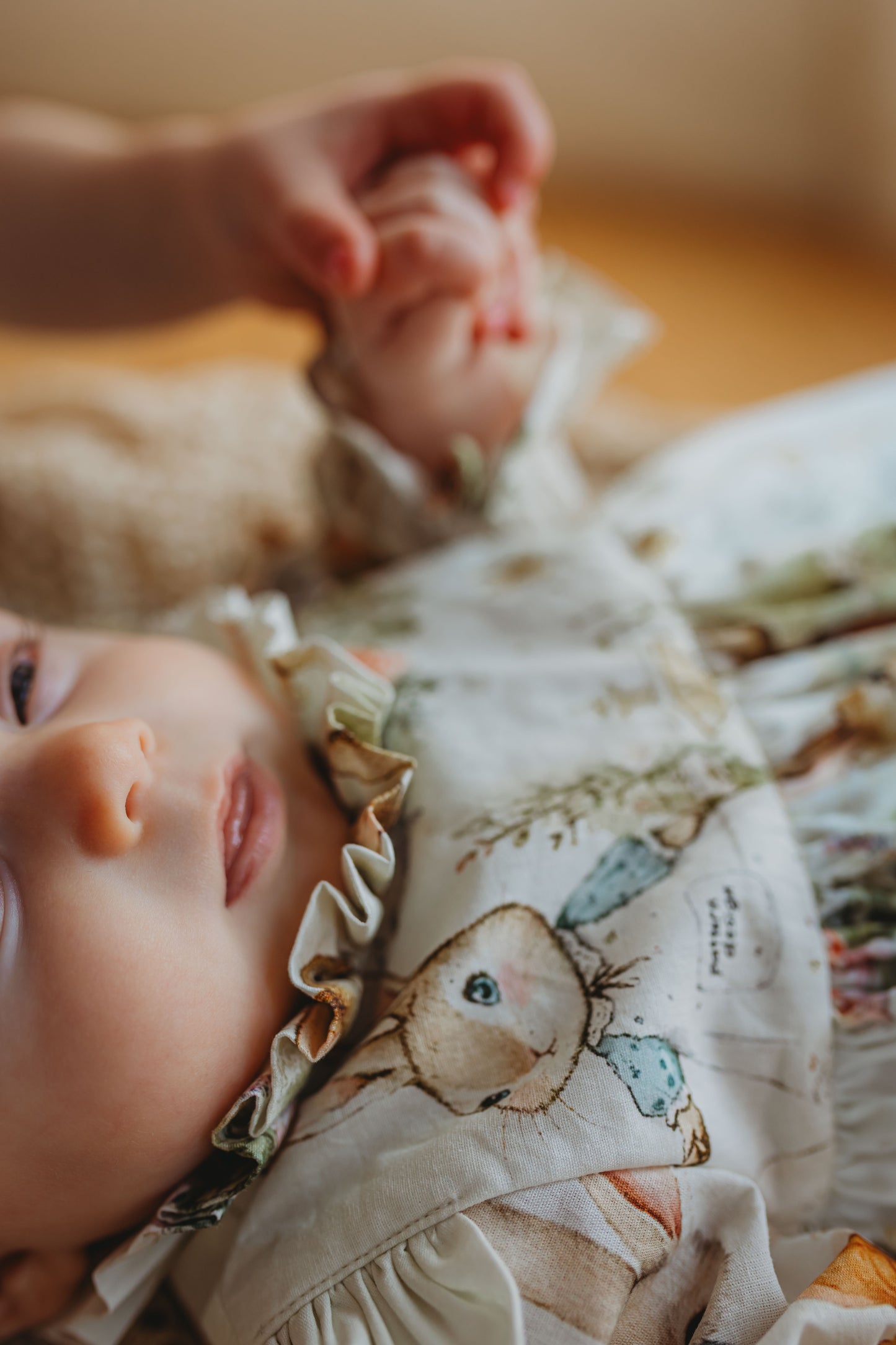Baby wearing a patterned outfit with a soft focus background