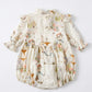 Floral baby romper with ruffled details on a white background