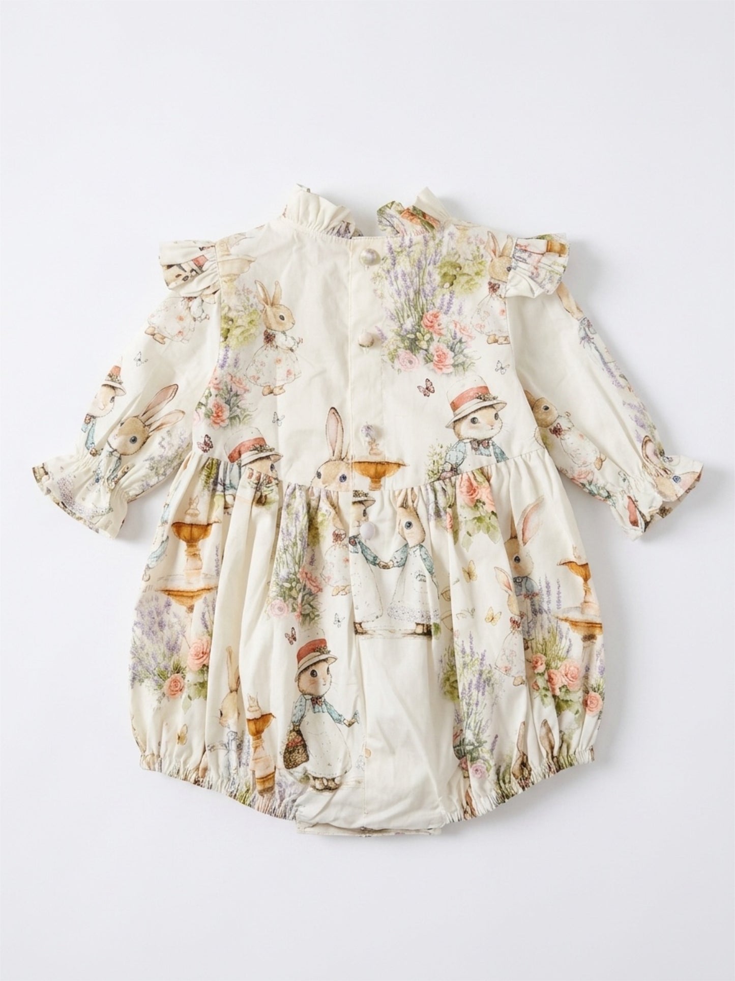 Floral baby romper with ruffled details on a white background