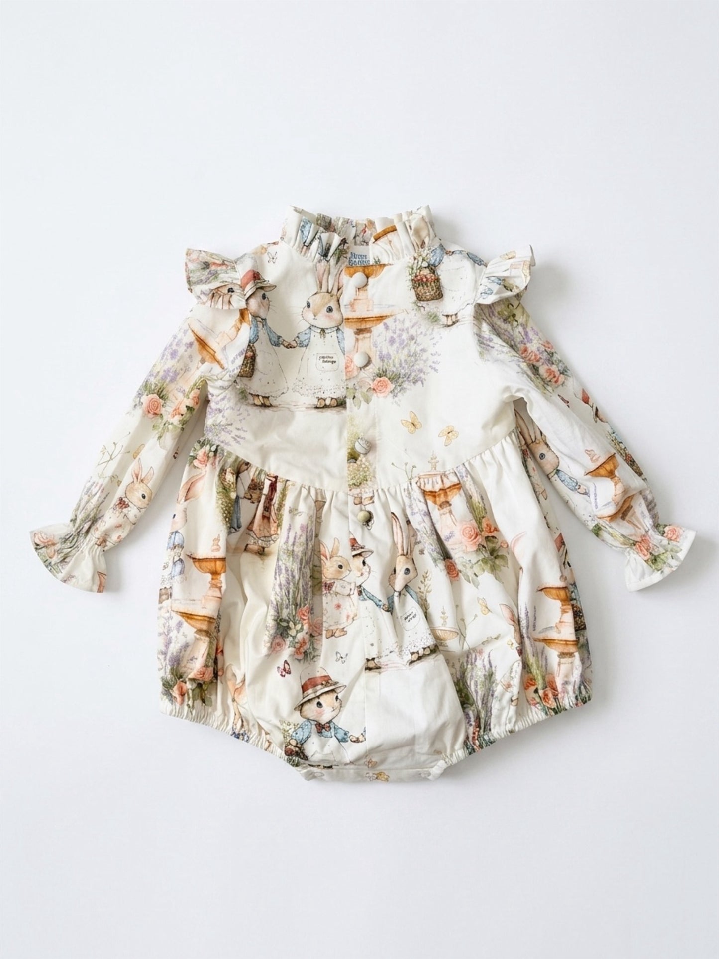 Floral baby romper with ruffled sleeves on a light gray background