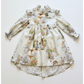 Children's dress with floral and animal print on a white background