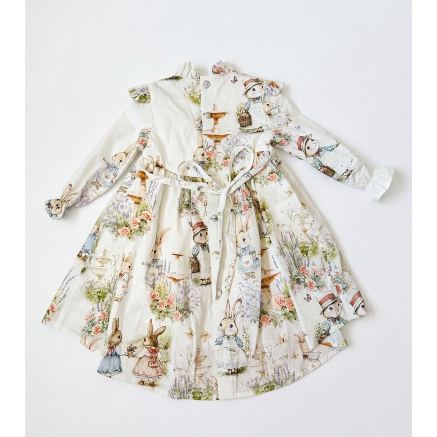 Children's dress with vintage-style rabbit print on a white background
