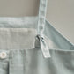 Light blue dress with a tie closure on a neutral background