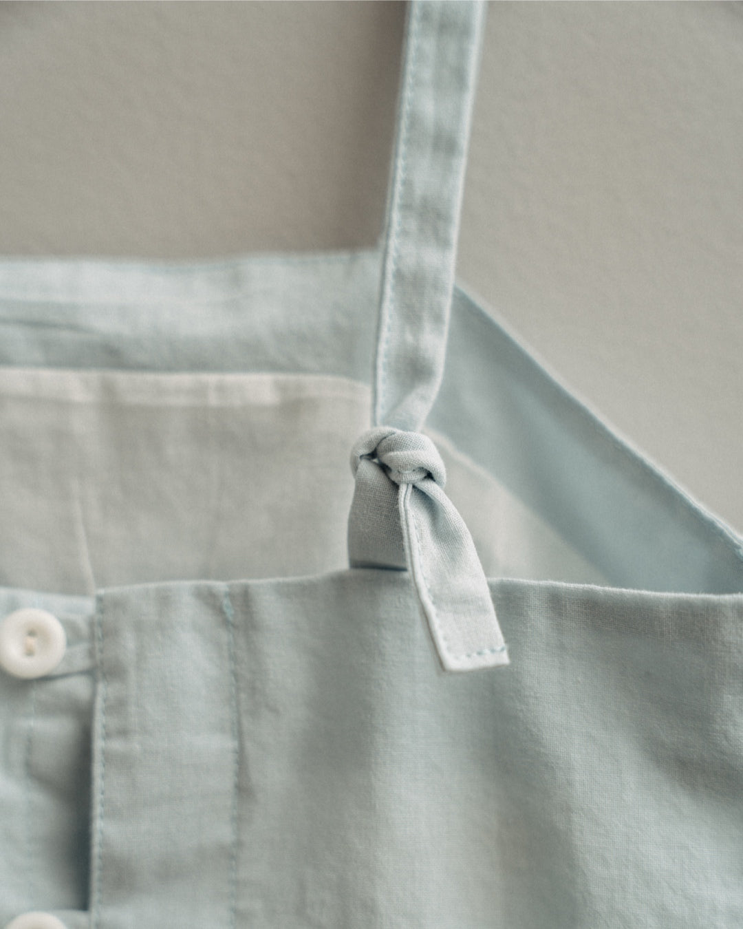 Light blue dress with a tie closure on a neutral background