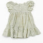 Green and white patterned dress on a white background