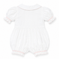 A white baby romper with short puff sleeves, ruffled collar, and ruffled leg openings, featuring delicate pink trim details.