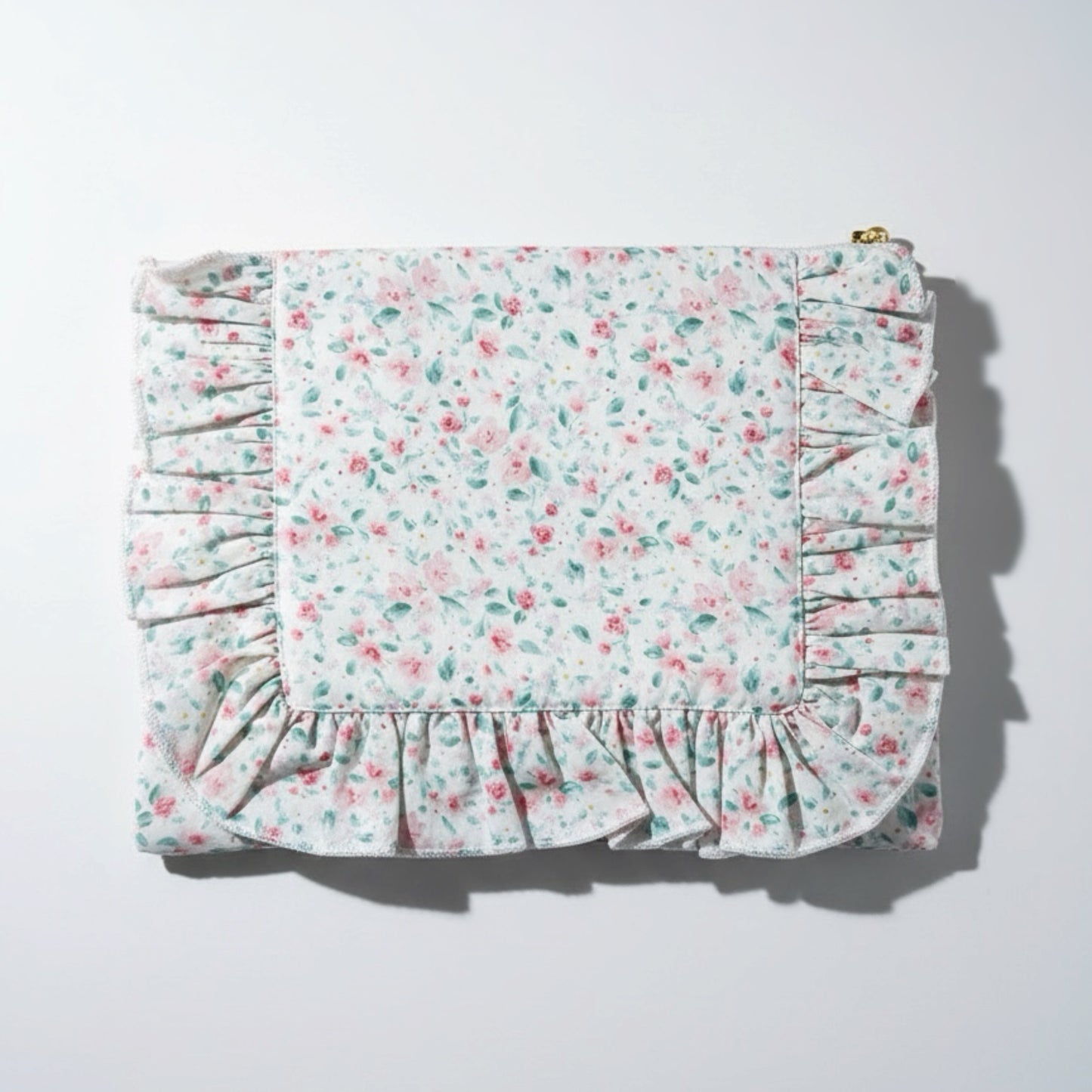 Floral patterned fabric with ruffled edges on a white background