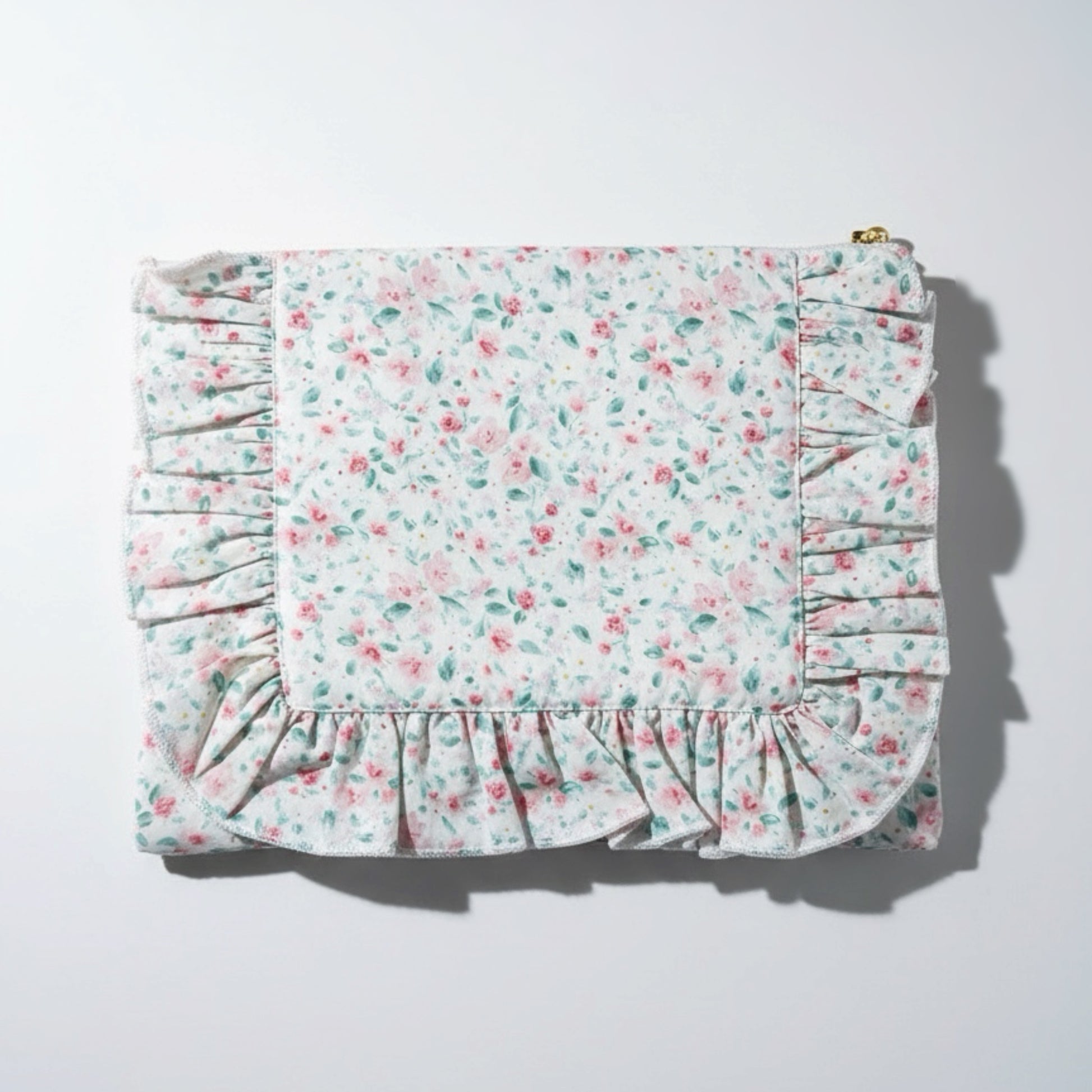 Floral patterned fabric with ruffled edges on a white background