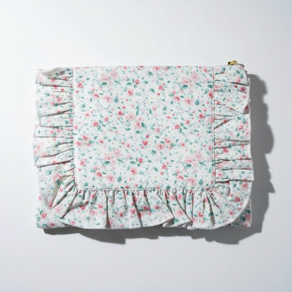 Floral patterned fabric with ruffled edges on a white background