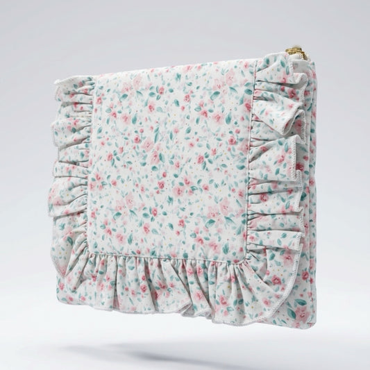 Floral patterned pouch with ruffled edges on a light gray background