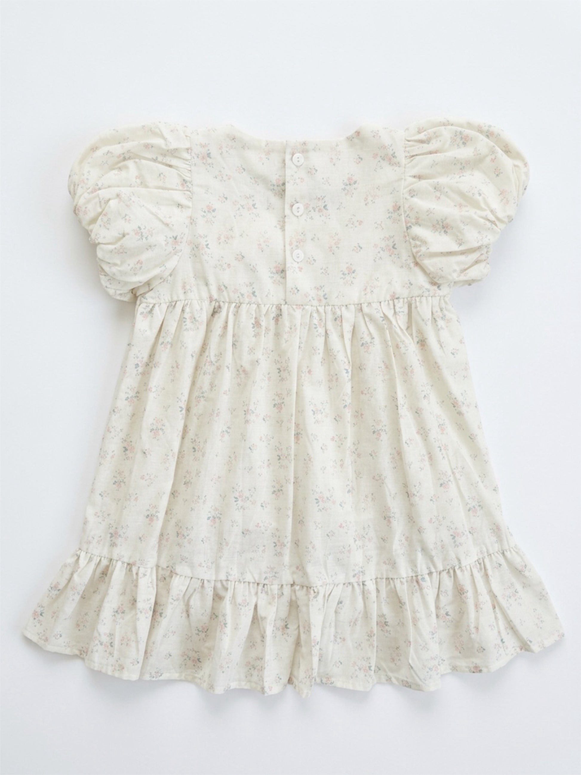 White floral dress with puff sleeves on a white background