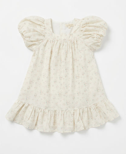 White baby dress with ruffled sleeves on a light gray background