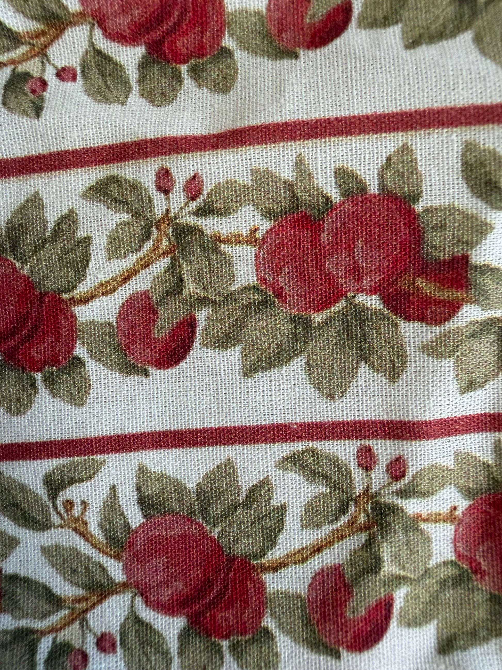 Fabric with red apple pattern on a white background