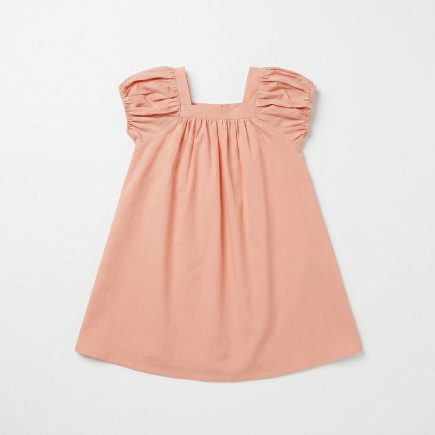 Pink dress with gathered puff sleeve on a light gray background