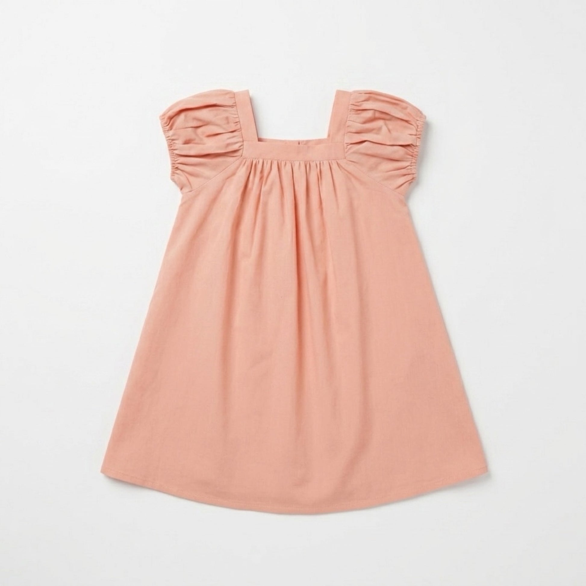 Pink dress with gathered puff sleeve on a light gray background