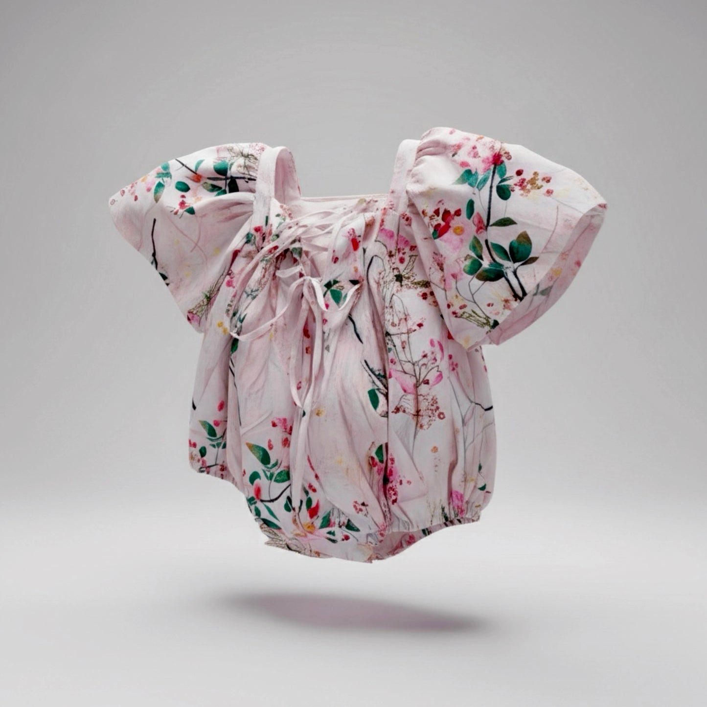 Floral baby romper on a gray background