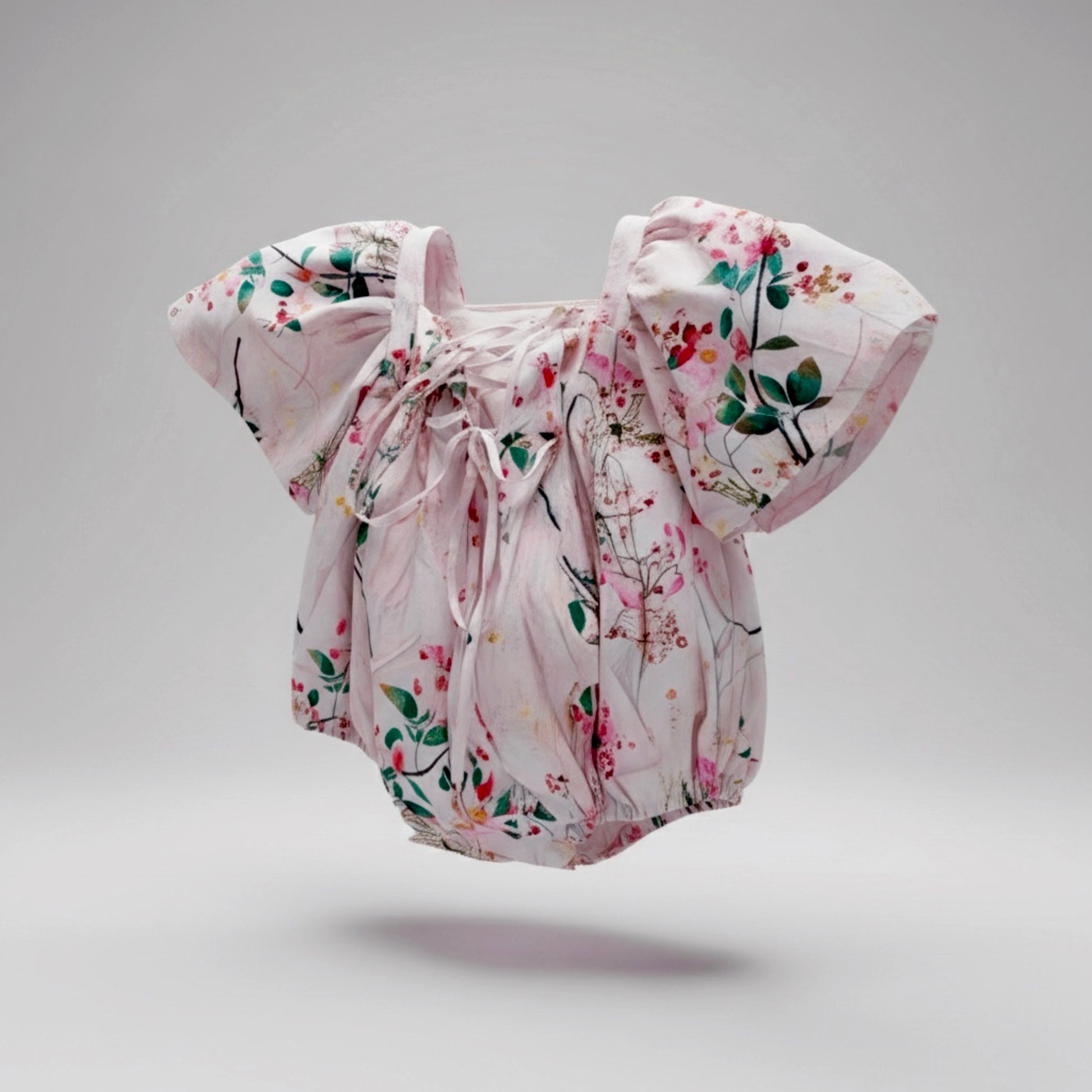 Floral baby romper on a gray background