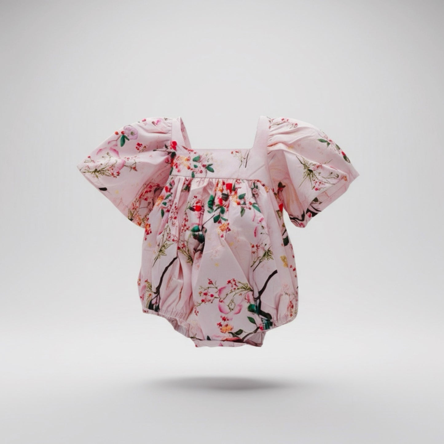 Floral baby romper on a light gray background