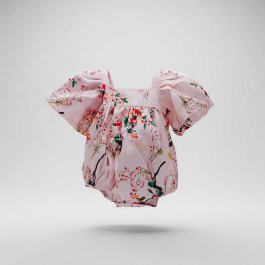 Floral baby romper on a light gray background