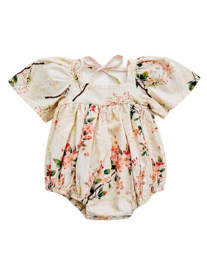 Floral baby romper with puff sleeves on a white background