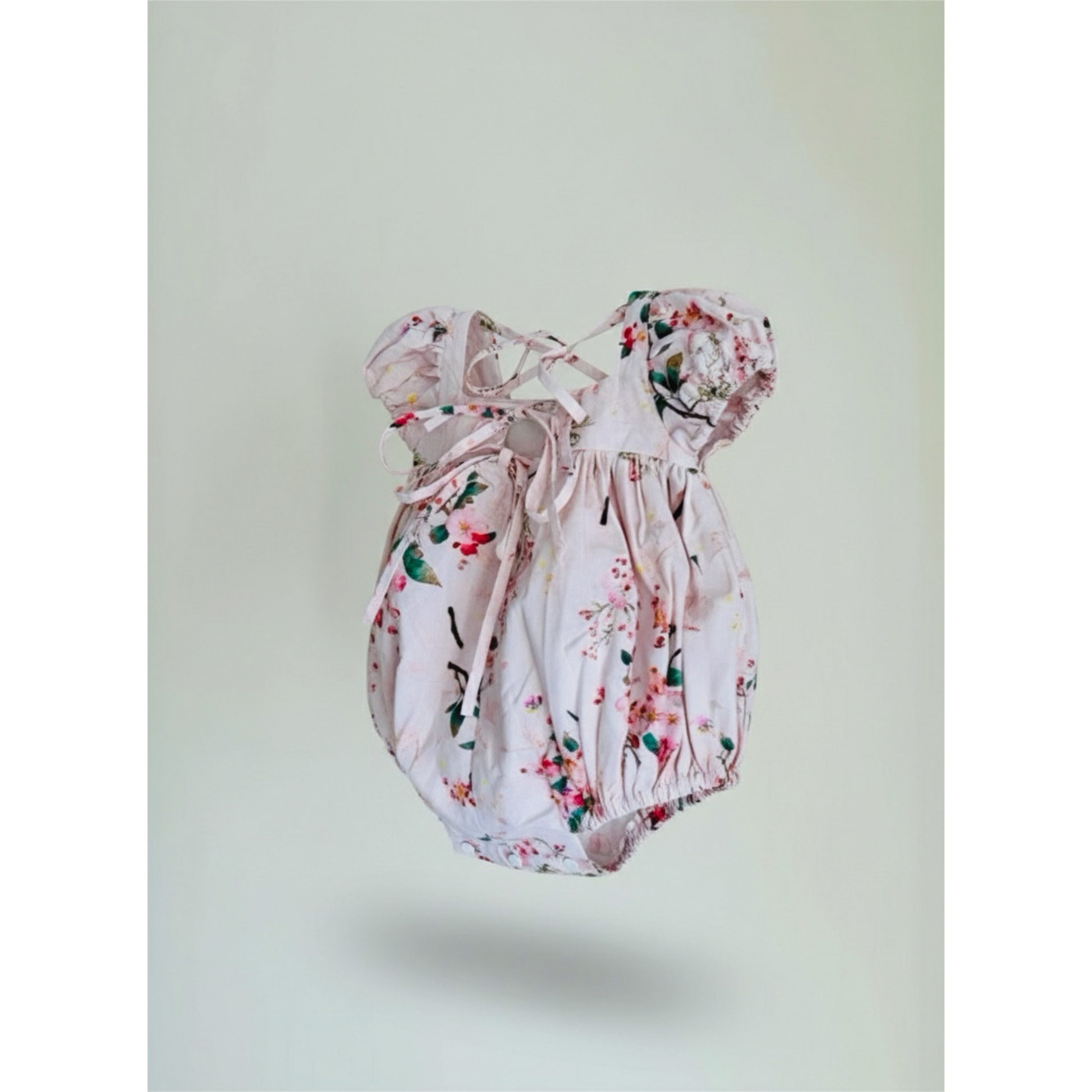 Floral baby romper on a light gray background