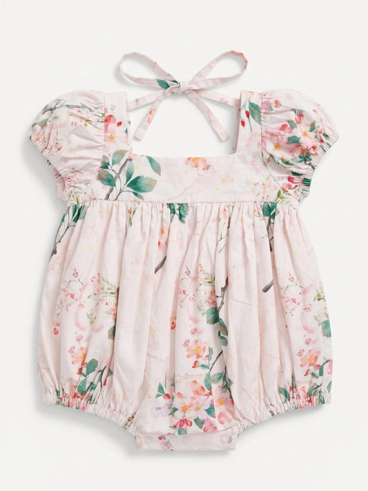 Floral baby romper with ruffled sleeves on a white background