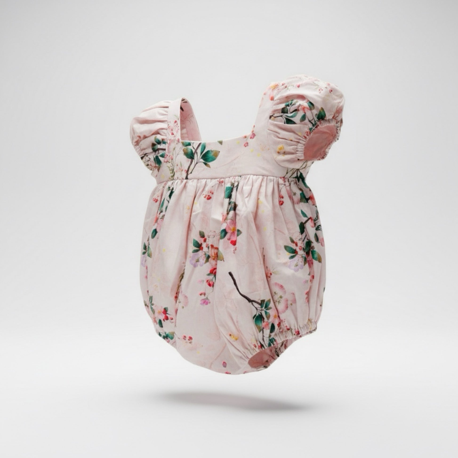 Floral baby romper on a light gray background