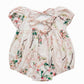 Floral baby romper with bow detail on a white background