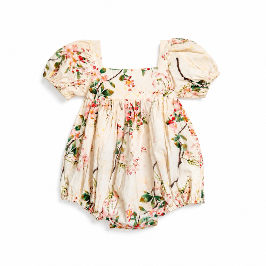 Floral baby romper with matching hat on a white background