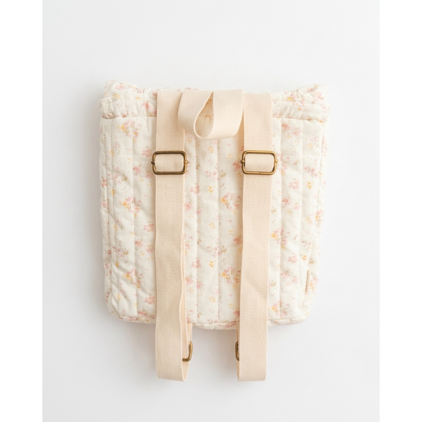 Floral-patterned backpack with beige straps on a white background