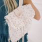 Floral backpack worn by a person with a blurred background