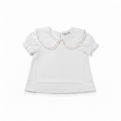 White blouse with lace collar on a white background
