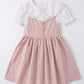 Pink dress with white collar on a light gray background