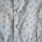 Floral patterned fabric with buttons on a light background