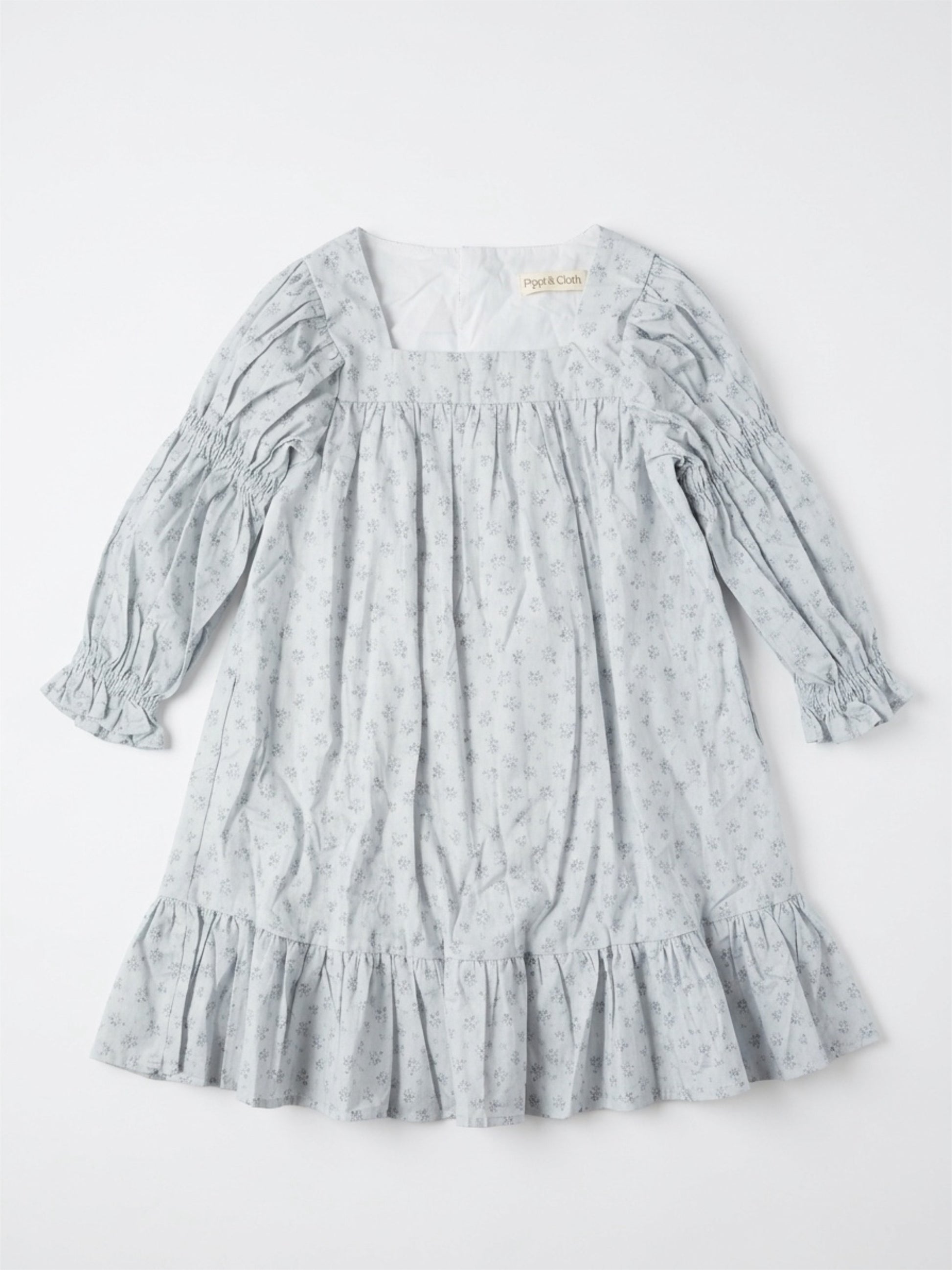 Light blue dress with floral pattern on a white background
