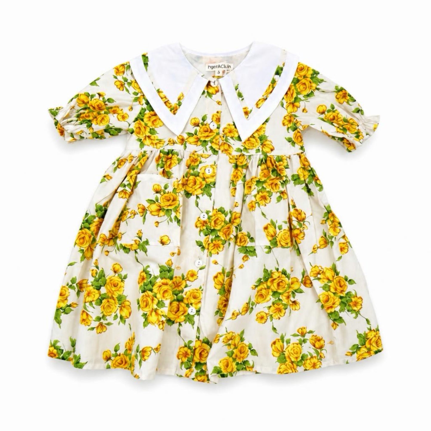 Children's dress with yellow floral pattern on a white background