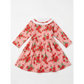 Pink dress with red floral pattern on a white background