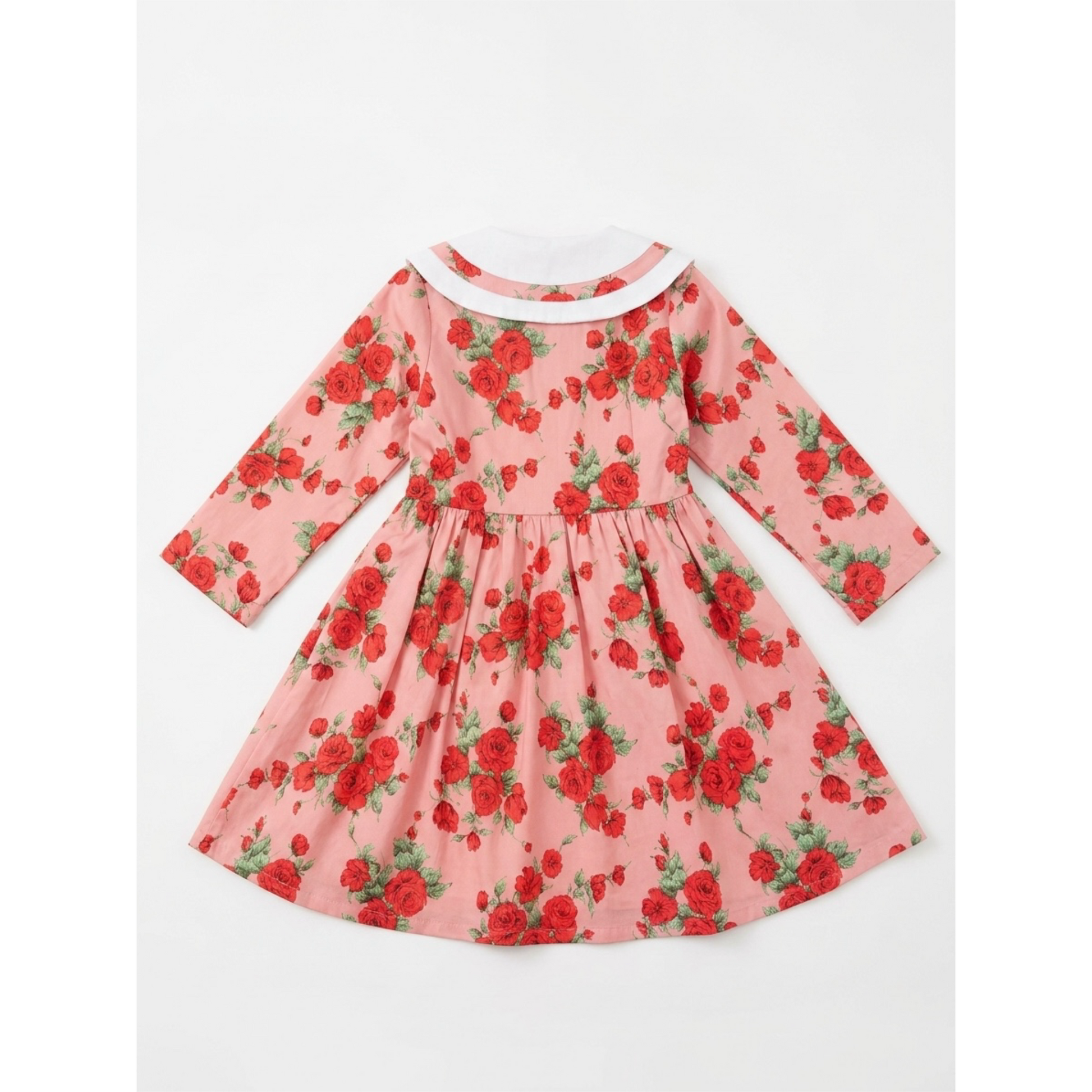 Pink dress with red floral pattern on a white background