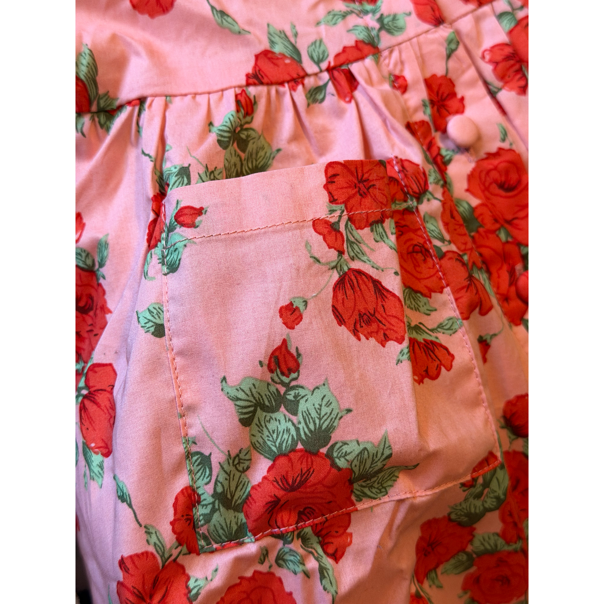 Close-up of a pink garment with red floral pattern