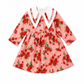 Pink dress with red floral pattern on a white background