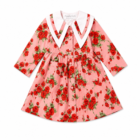 Pink dress with red floral pattern on a white background