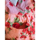 Floral dress with red flowers and green leaves on a pink background