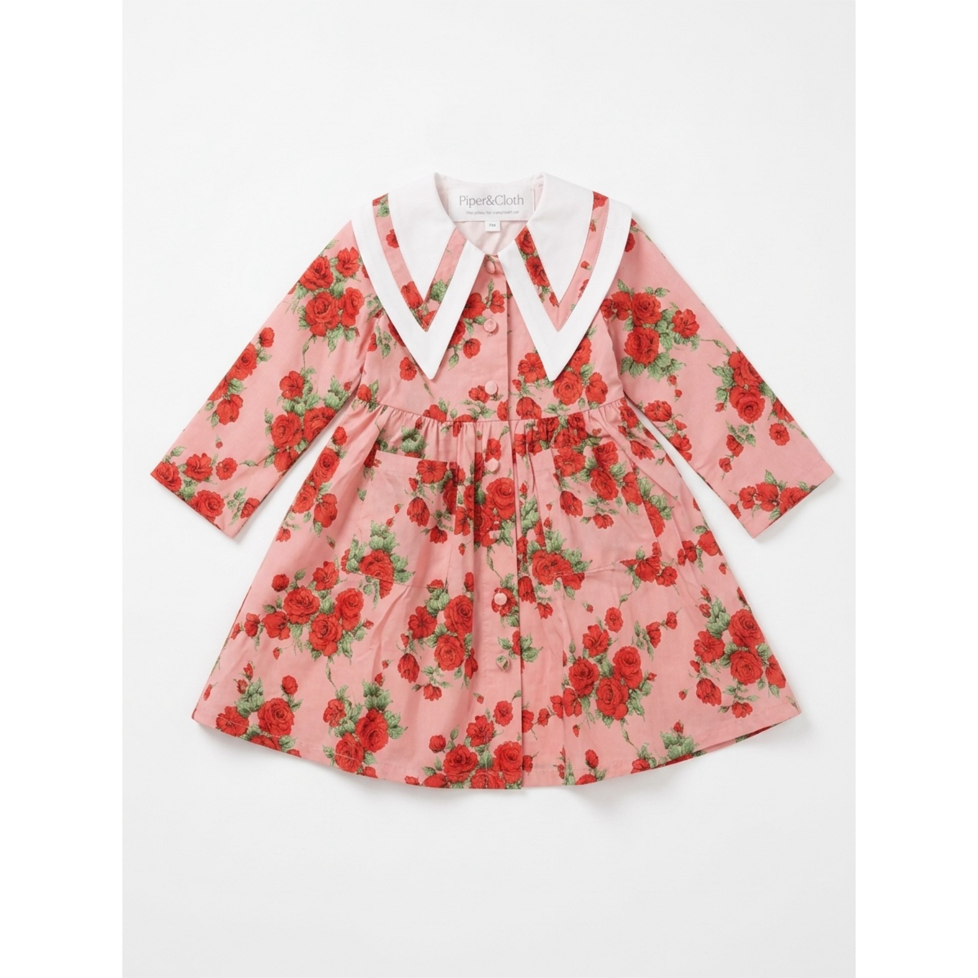 Pink floral dress with a white collar on a white background