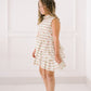 Girl wearing a floral dress against a white background