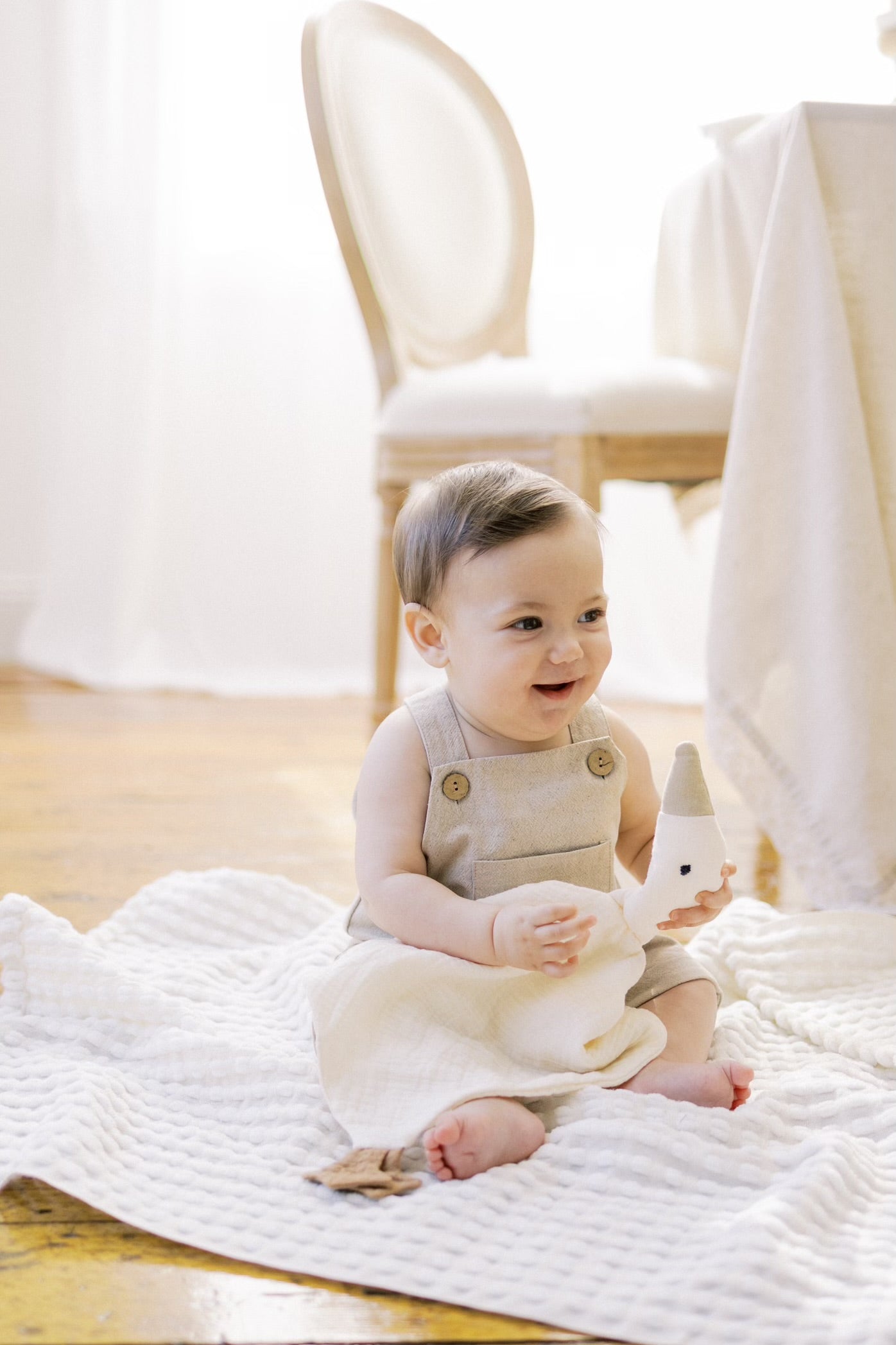 Baby holding a Goose Lovey 